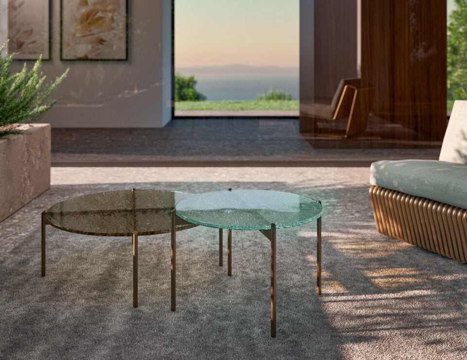 Round glass coffee tables with metal legs in an outdoor seating area