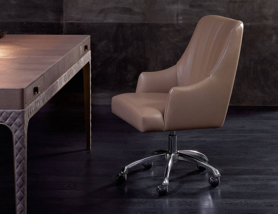 Leather office chair with chrome base next to desk