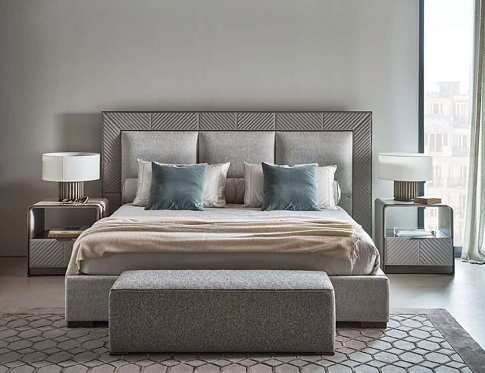 Leather upholstered low storage bed with padded headboard in bedroom setting