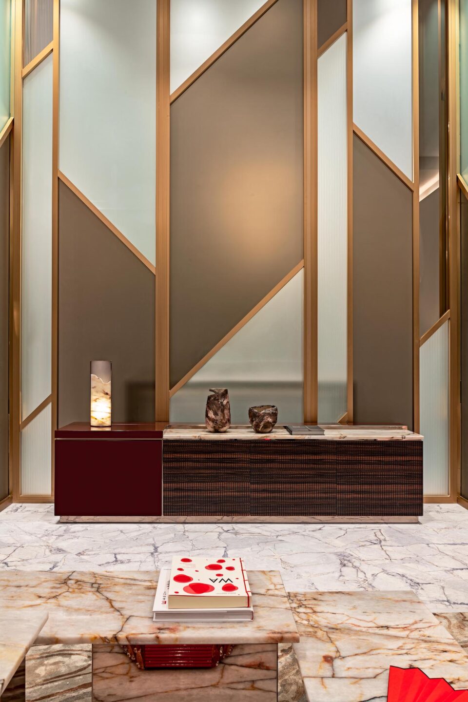 Wood credenza with walnut finish used as storage furniture against patterned wall