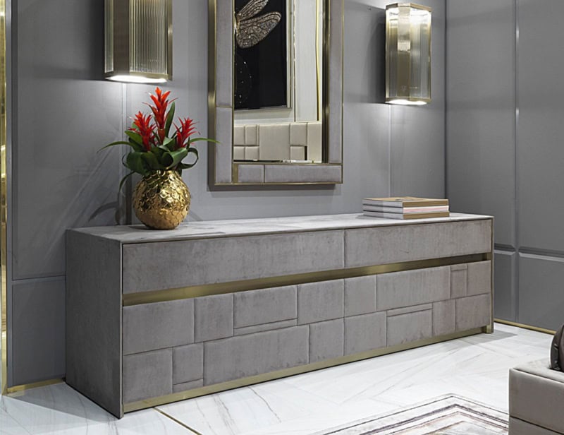 Rectangular gray sideboard with brass trim in a modern interior