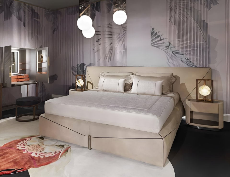 Leather bed with upholstered headboard and side tables in bedroom setting