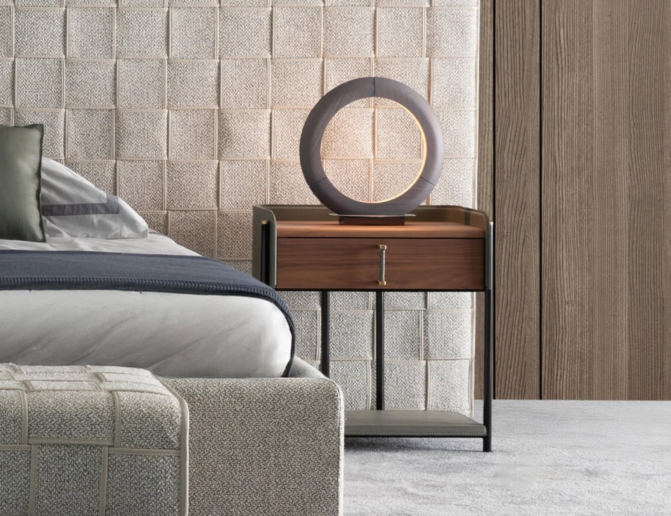 Leather and wood bedside table with drawer in bedroom setting