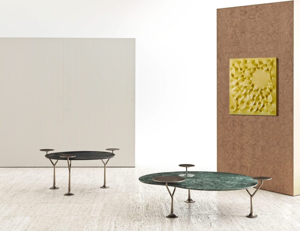 Round marble coffee tables with metal legs and Guatemala finish in a living room setting