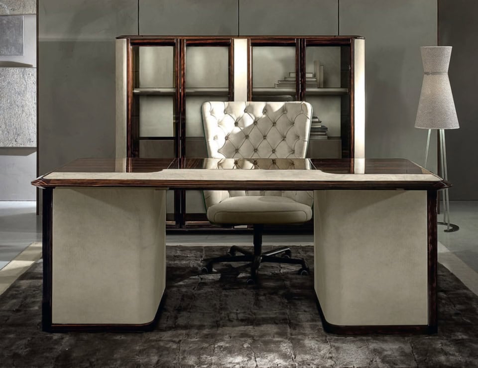 Wood desk with ebony finish and upholstered chair in office setting