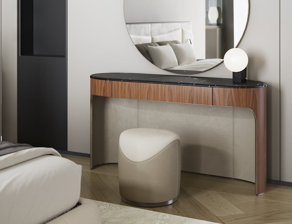 Leather ottoman seating placed in front of a wood and marble console in a bedroom setting