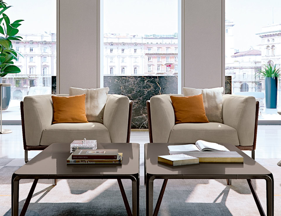 Leather Milano sofa chairs with cushions in a living room setting