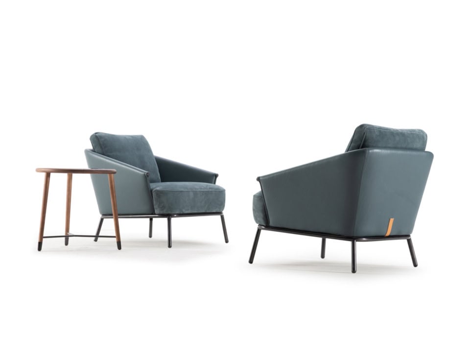 Leather armchairs with metal legs beside small wooden table