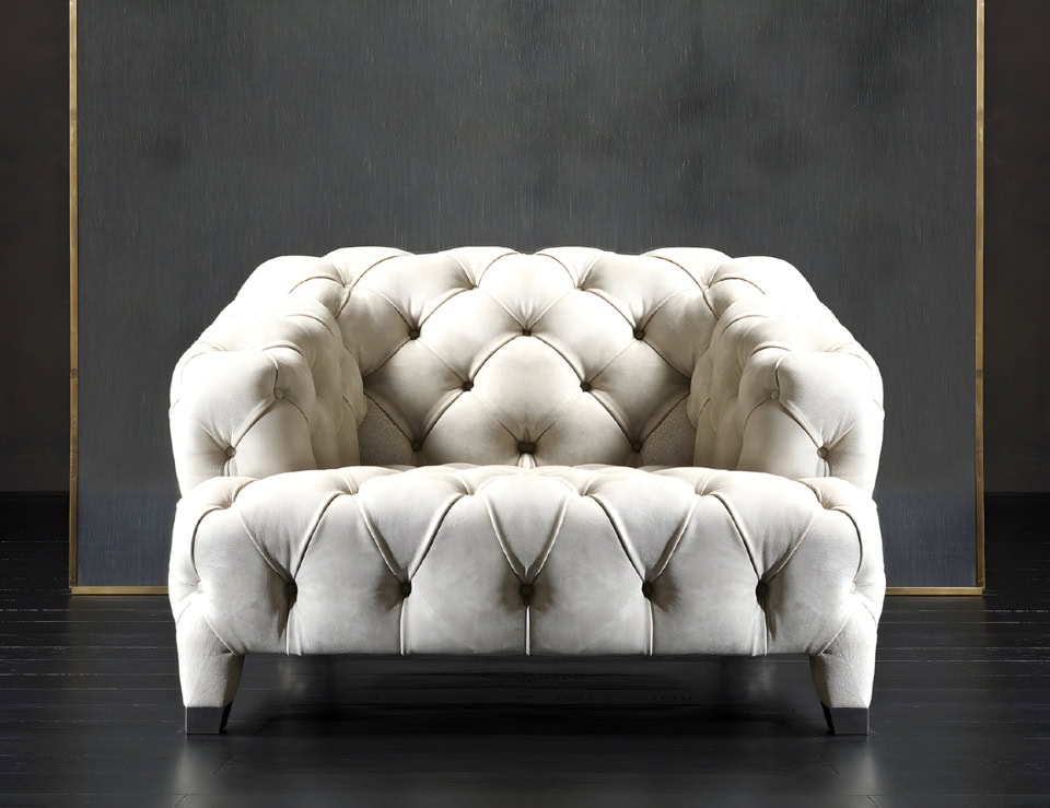 Tufted leather sofa chair with curved armrests