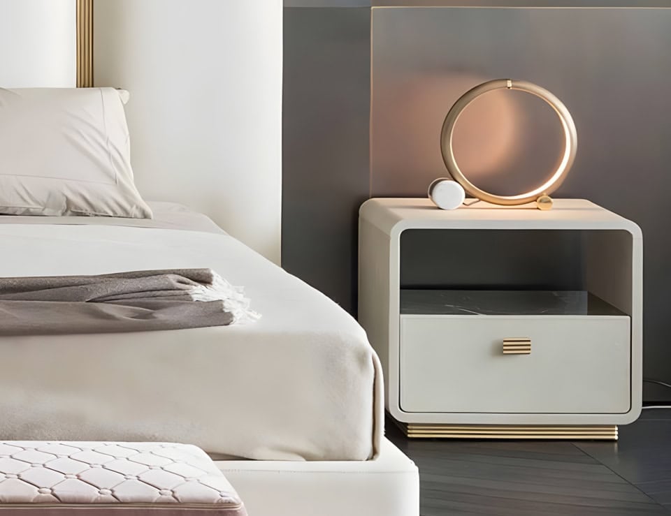 Leather bedside table with drawer and open shelf beside bed