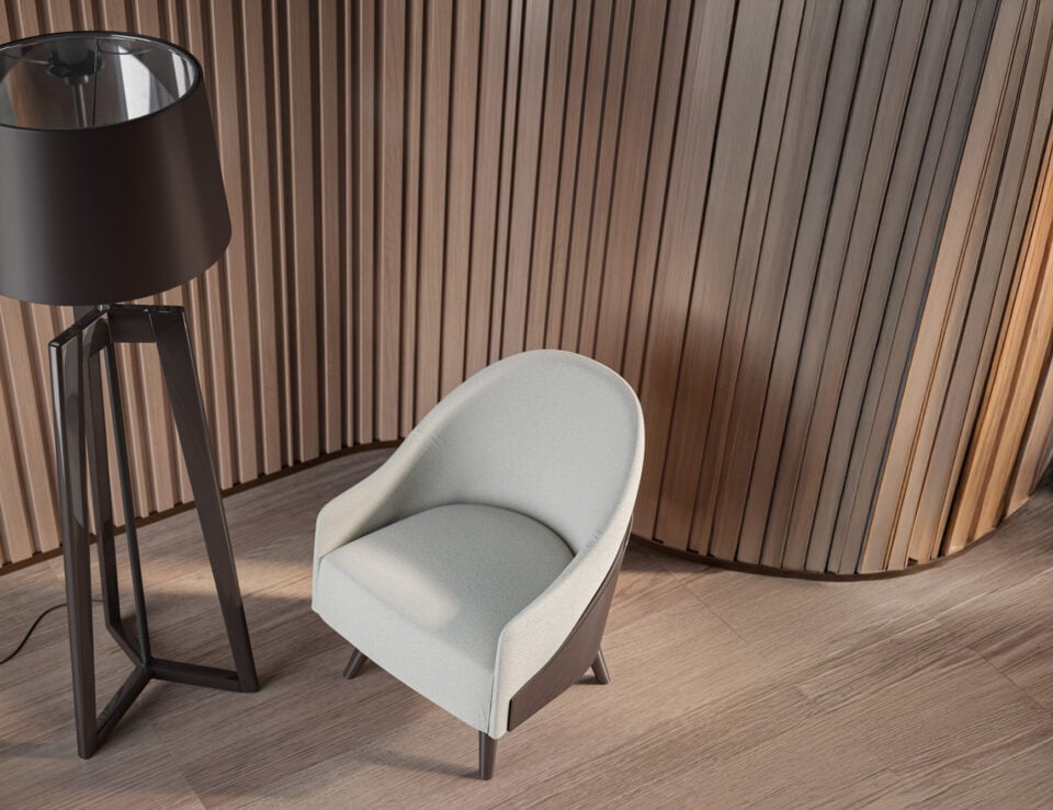 Upholstered fabric lounge armchair with curved backrest in wood interior setting