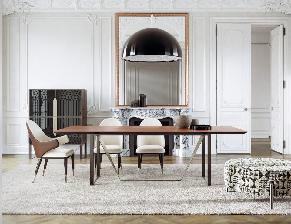 Leather dining chair with armrests and wooden legs around a dining table