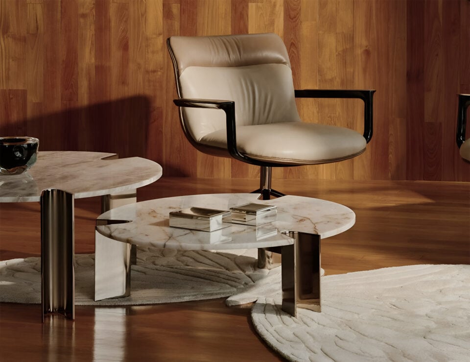 Round marble coffee table with Dover White finish and metal legs in a living room setting