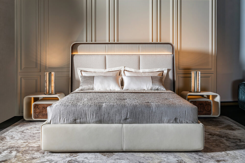 Fabric storage bed with upholstered headboard and side tables in bedroom setting