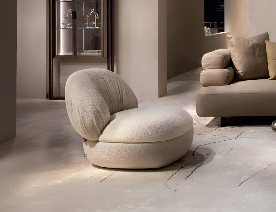 Leather swivel sofa chair with rounded seat and backrest in living room setting