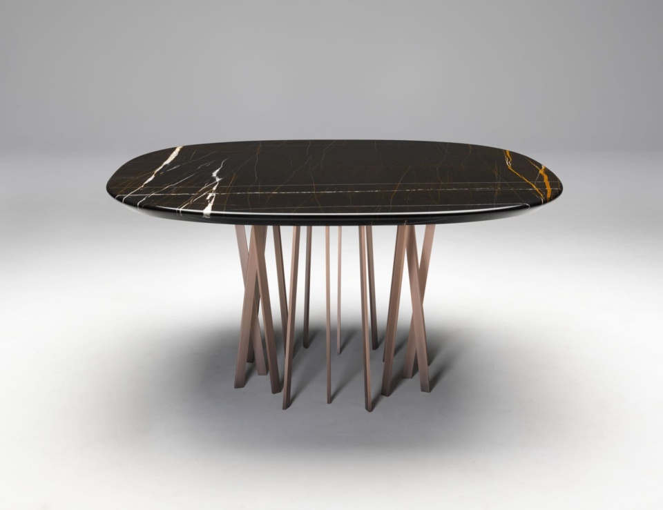 Oval marble dining table with Sahara Noir finish and metal base