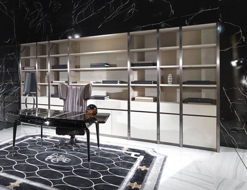 Office with metal frame desk, leather chair and wall shelving units