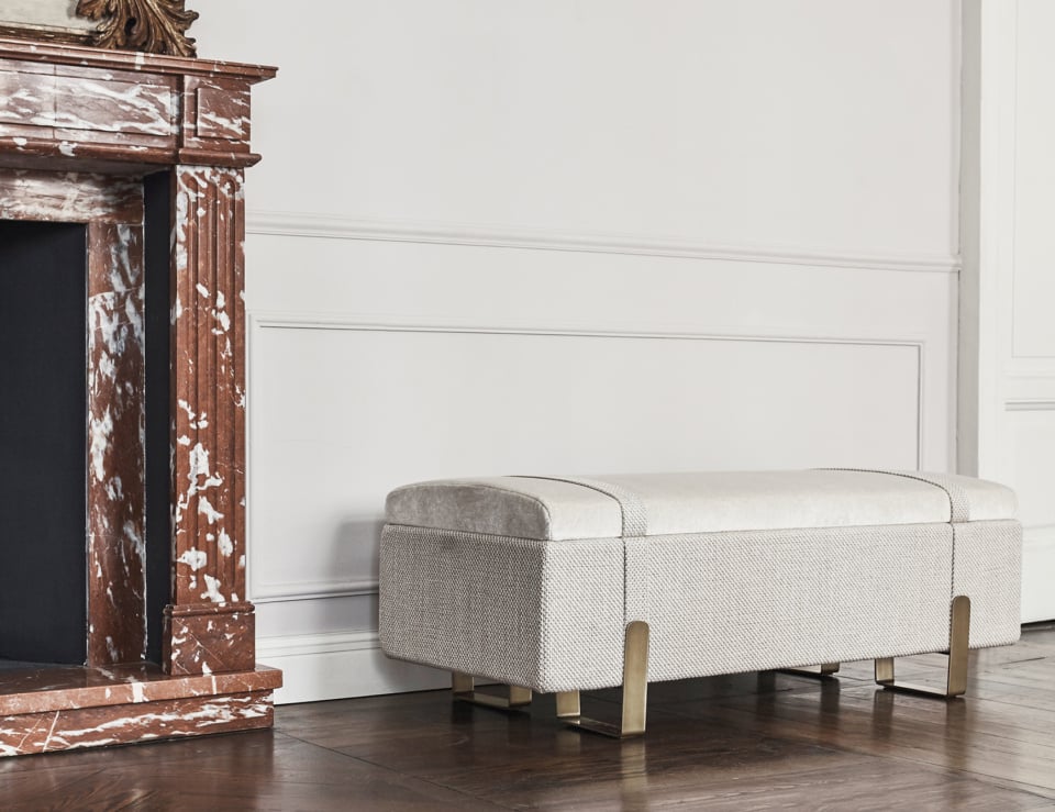 Fabric bench with metal legs placed in a living room setting