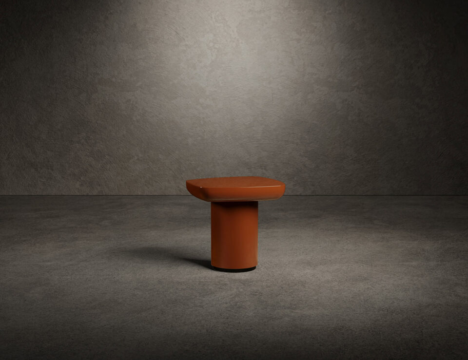 Lacquered wood coffee table with round base in neutral room