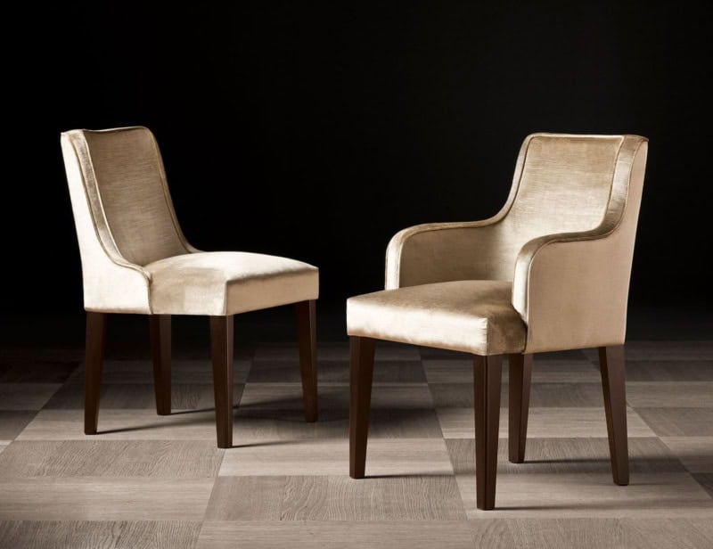 Two upholstered dining chairs with wooden legs