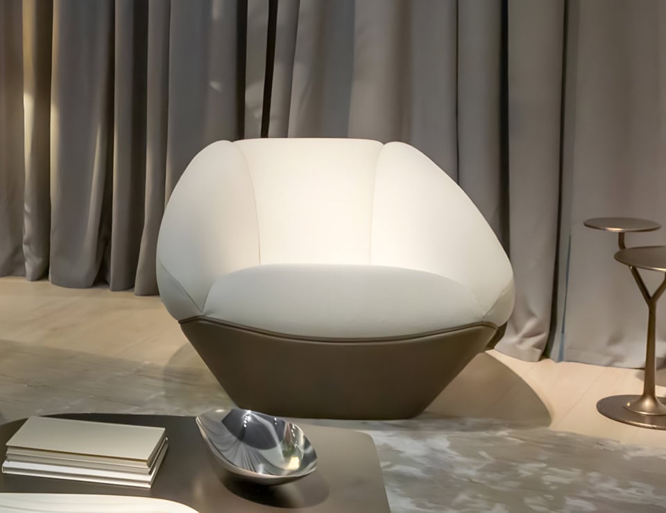 Leather swivel armchair with rounded base in living room setting