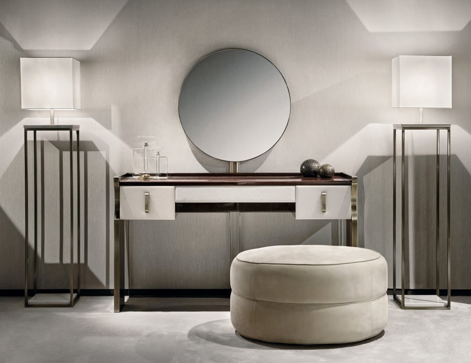 Round leather ottoman in living room setting