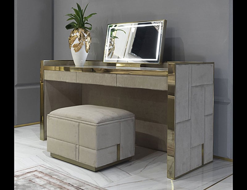 Upholstered vanity table with gold metal trim and matching stool
