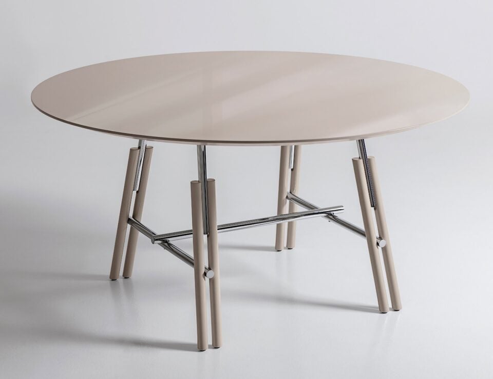 Oval wood dining table with metal legs on light surface