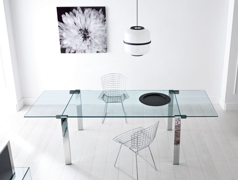 Rectangular glass dining table with chrome legs and metal chairs