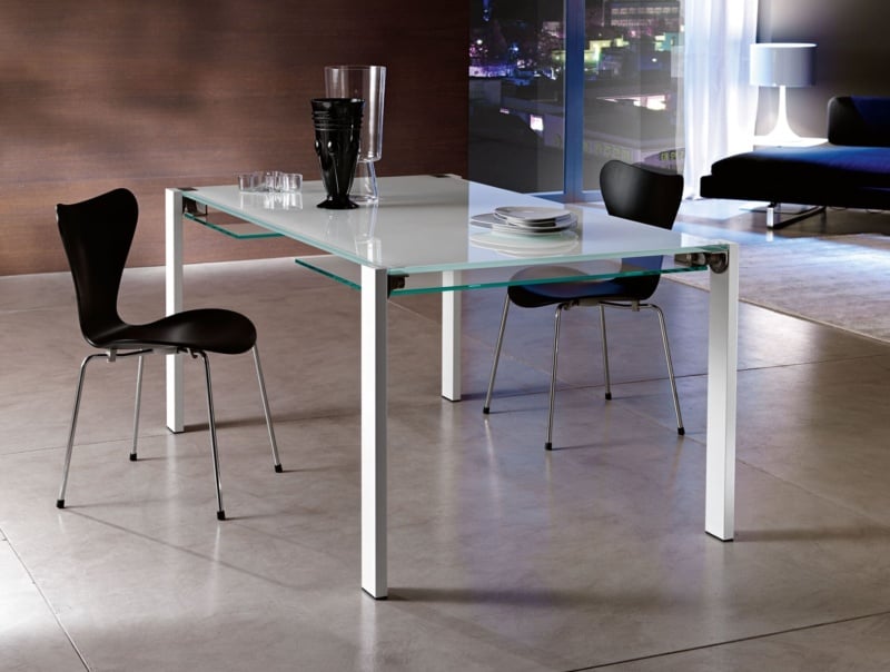 White glass dining table with metal legs in a living room