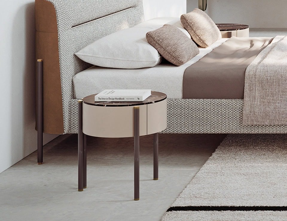 Marble bedside table with Sahara Noir finish beside bed