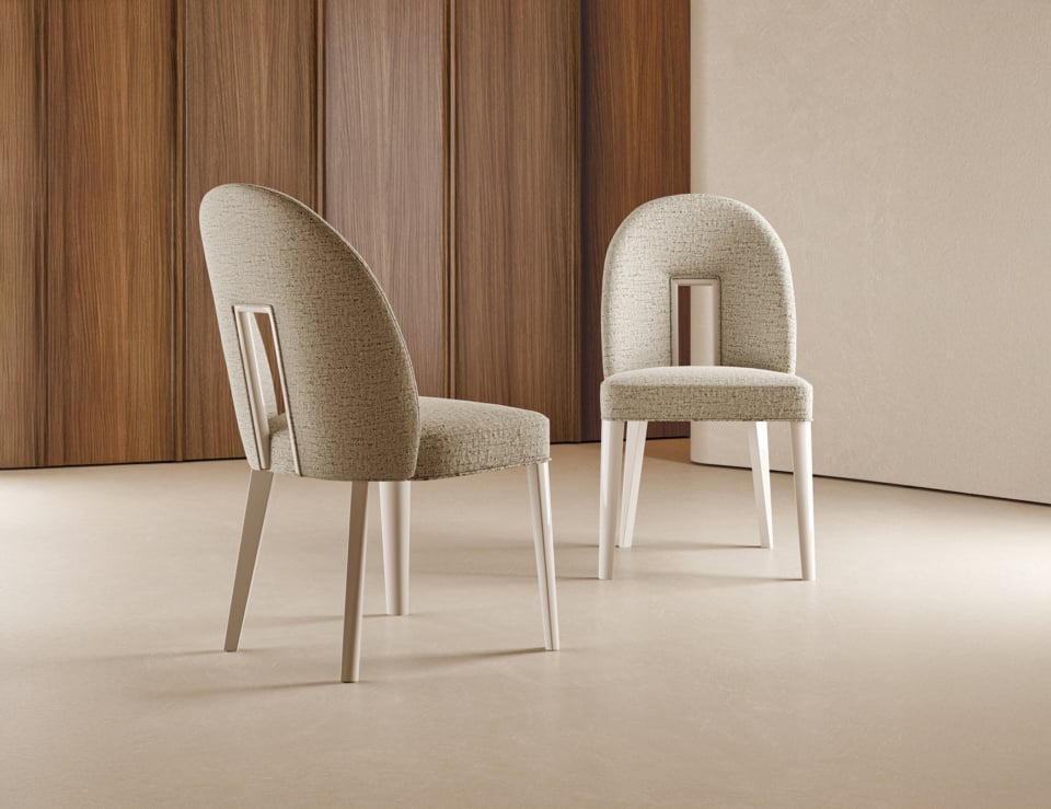 Fabric dining chairs with rounded backs and light wood legs