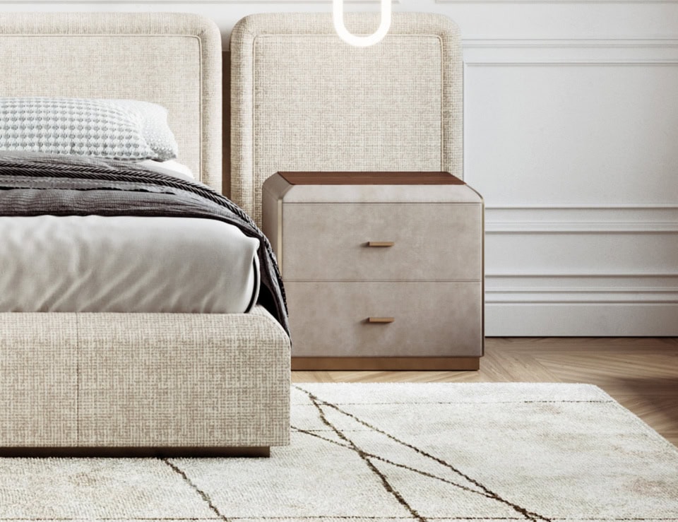 Leather bedside table with two drawers beside upholstered bed
