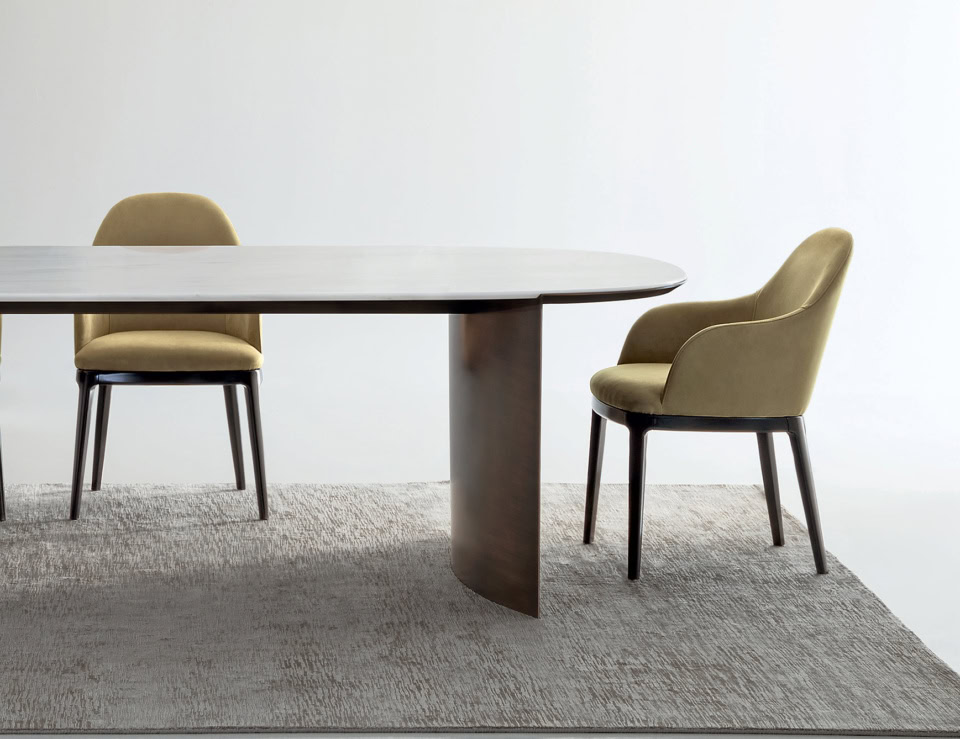 Leather dining chairs with wooden legs beside dining table