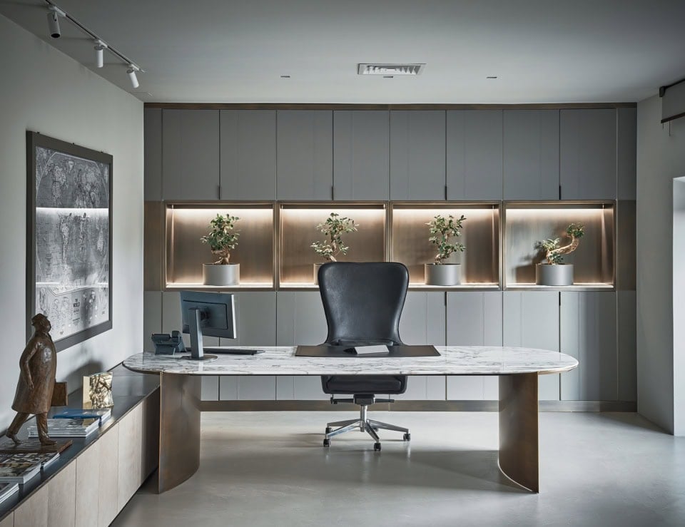 Calacatta marble office desk with metal base and chair in office setting