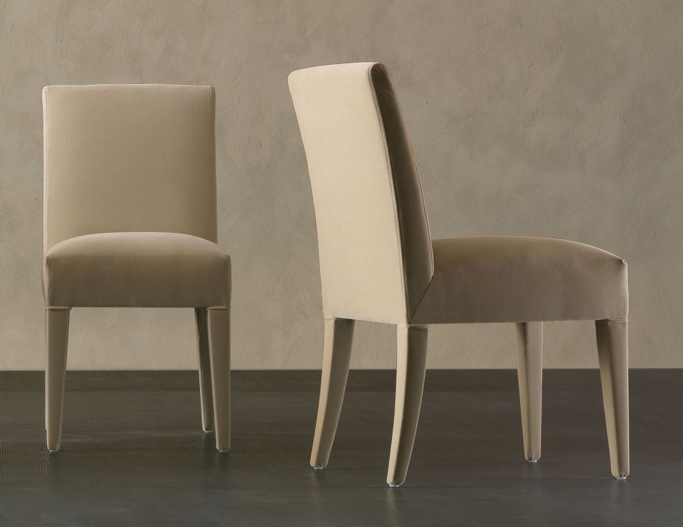 Upholstered wood dining chairs with straight backs and tapered legs