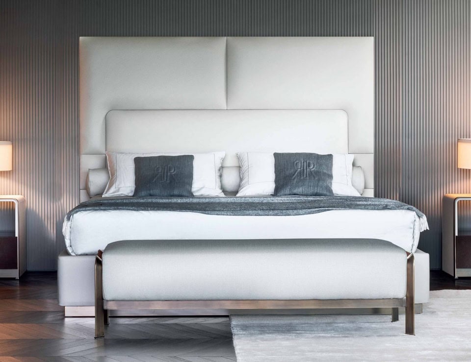 Leather storage bed with upholstered headboard and metal frame in bedroom setting