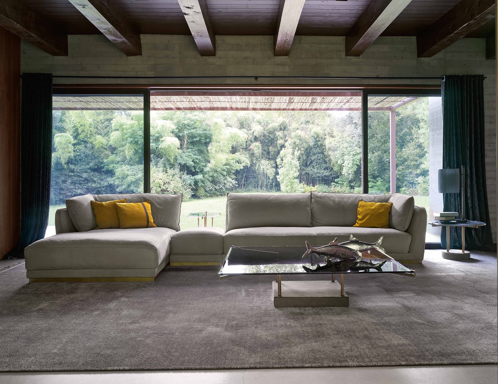 Glass Silvie coffee table with metal base in living room setting