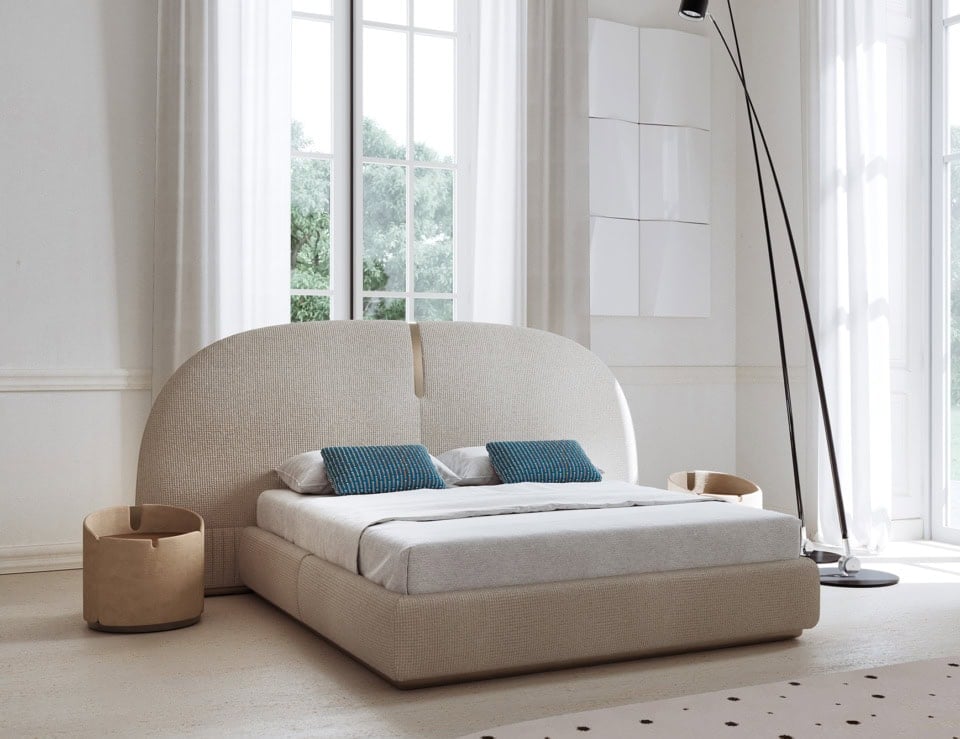 Fabric upholstered storage bed with curved headboard in bedroom setting