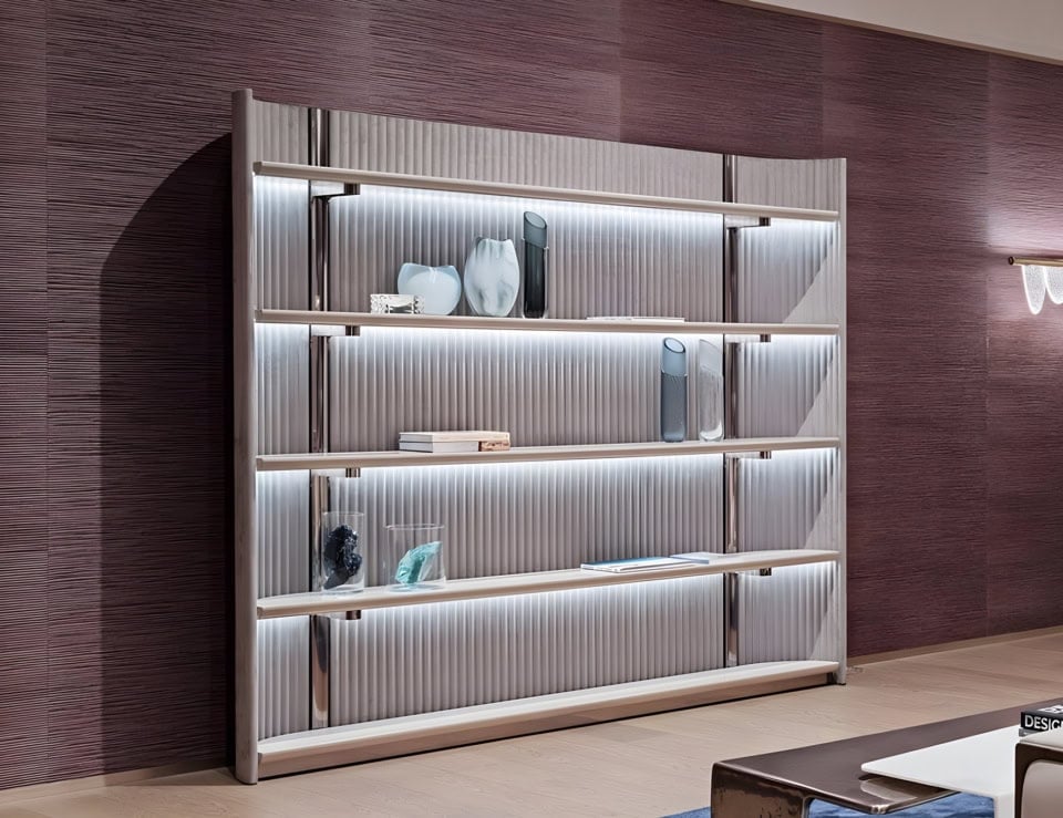 Glass, leather, and metal bookcase with shelving in a living room setting