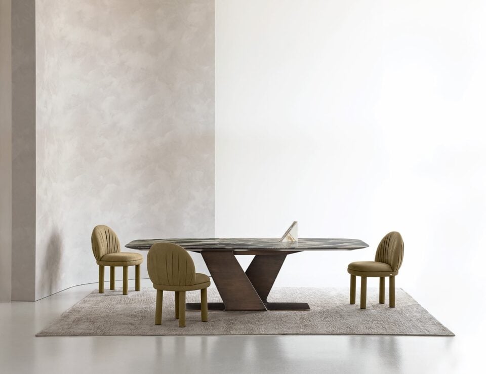 Rectangular marble dining table with dark base in dining room setting