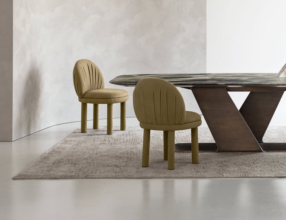 Leather dining chairs with upholstered seats beside a table in a dining room setting